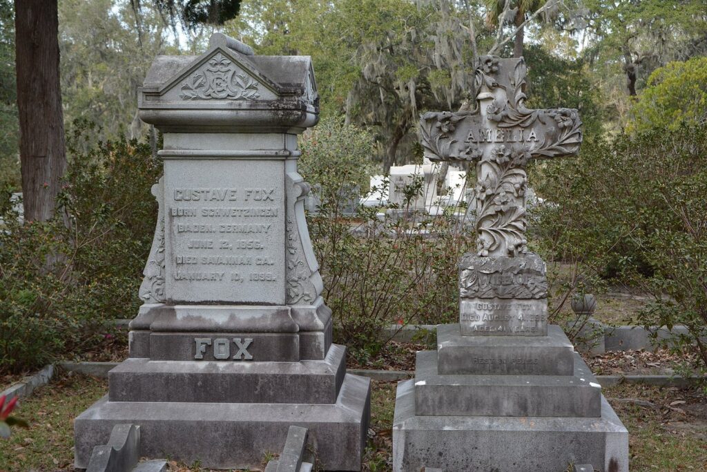 Weathered granite and marble grave monuments under moss-hung trees in Bonaventure Cemetery, Savannah