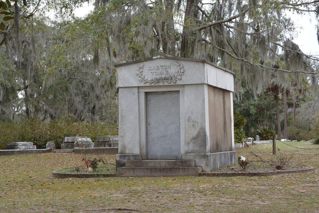 A marble family tomb under live oaks hung with Spanish moss at Bonaventure Cemetery
