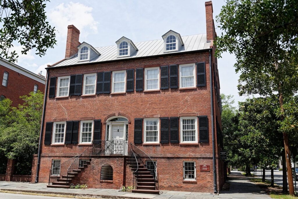 Best things to do in Savannah for first-time visitors: the red brick Federal-style Davenport House with black shutters and a double front stair