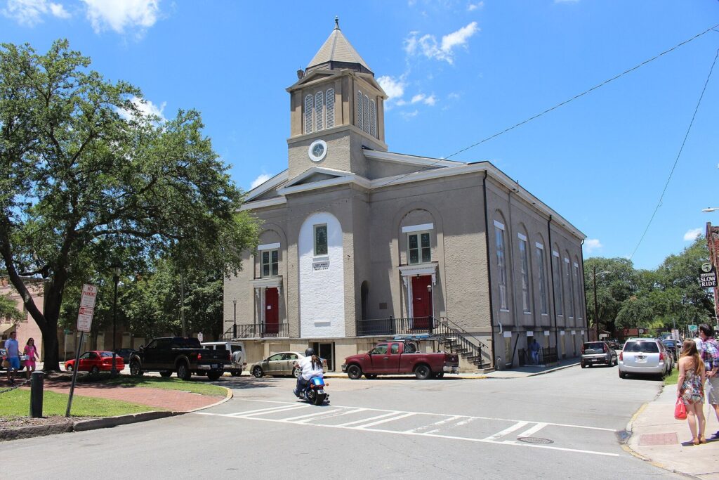 The tan stucco facade and bell tower of First African Baptist Church on Franklin Square in Savannah