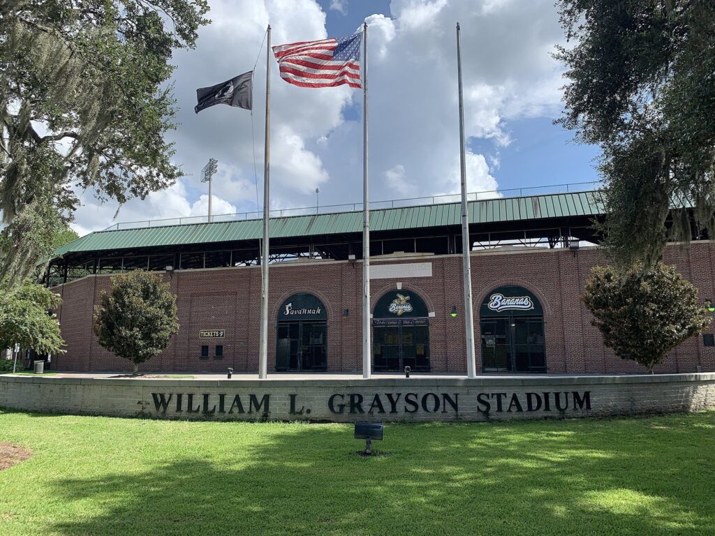 The brick entrance of William L. Grayson Stadium in Savannah, with flags flying out front