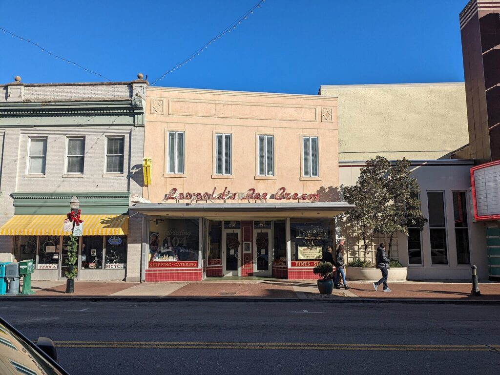 The pink storefront and script sign of Leopold's Ice Cream on East Broughton Street