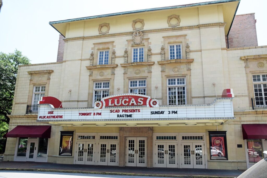 The cream facade and red marquee of the Lucas Theatre on Abercorn Street in Savannah