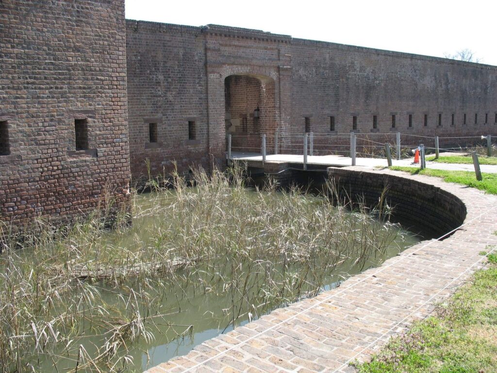 The brick walls, moat and arched gate of Old Fort Jackson in Savannah