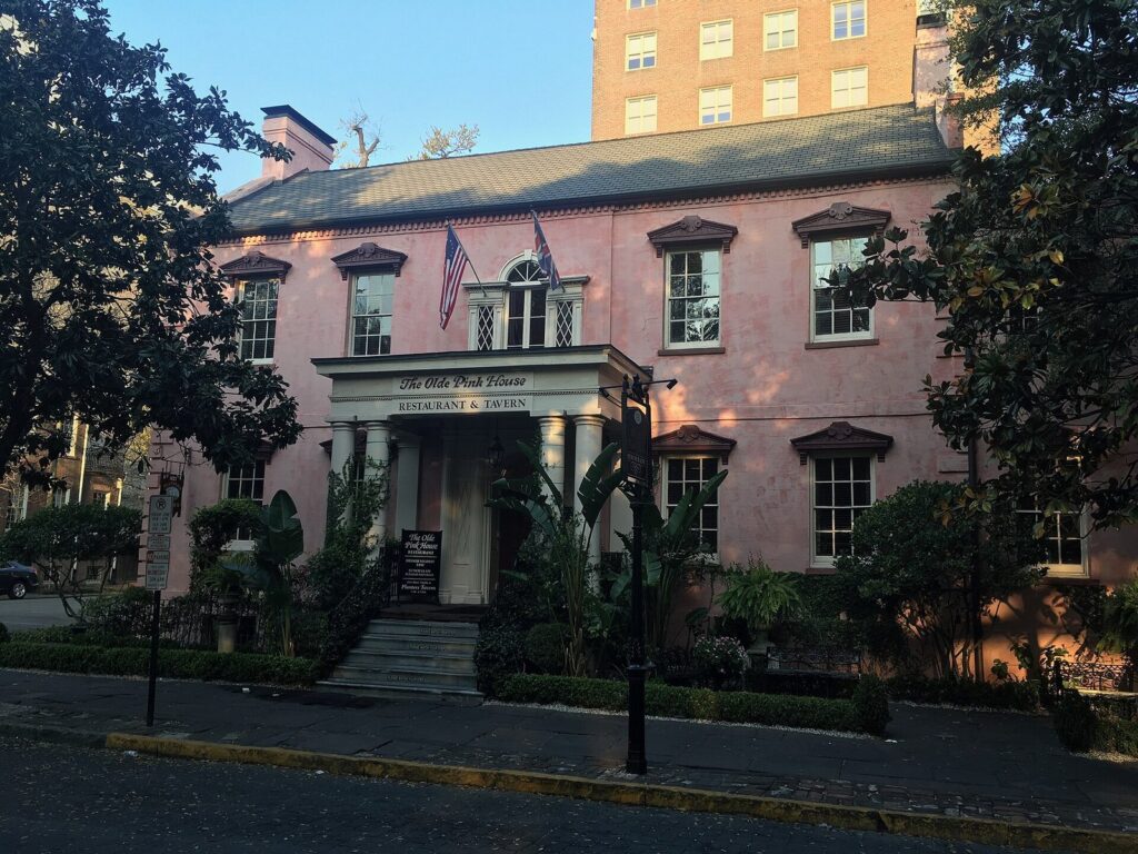 Best restaurants in Savannah GA: the pink stucco facade of The Olde Pink House restaurant and tavern on Reynolds Square