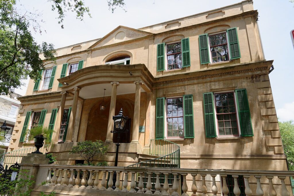 The stucco facade and green shutters of the Owens-Thomas House on Oglethorpe Square in Savannah