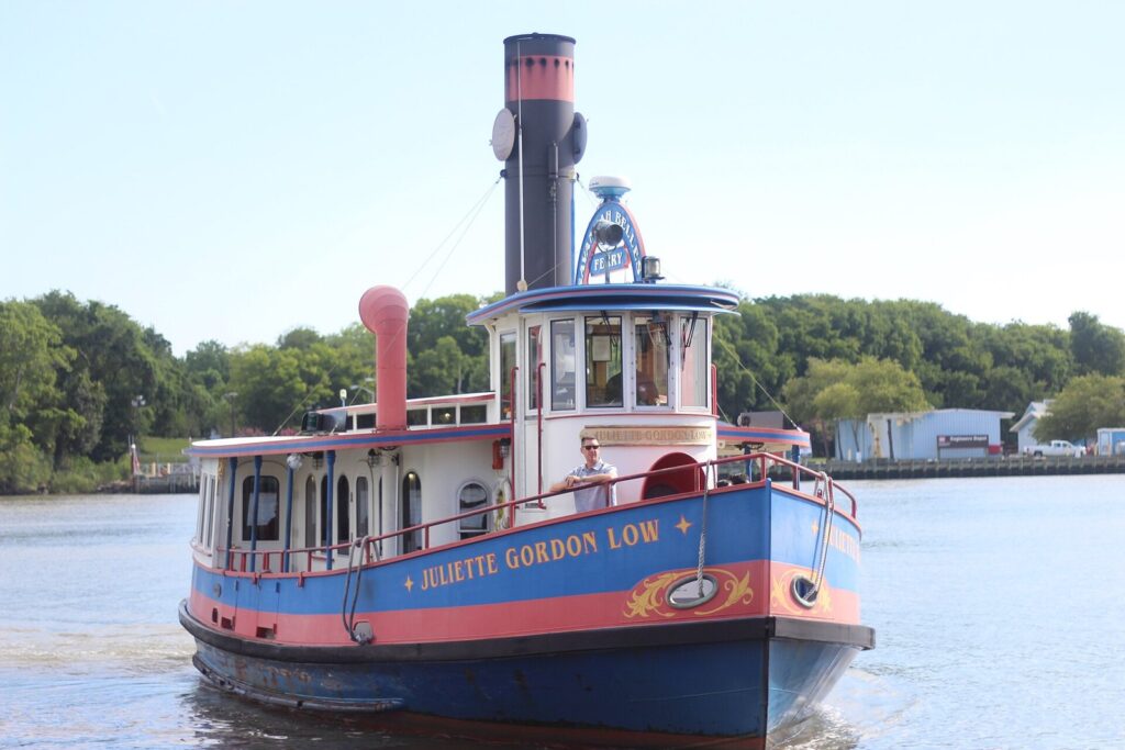 The blue and red Savannah Belles Ferry Juliette Gordon Low crossing the Savannah River