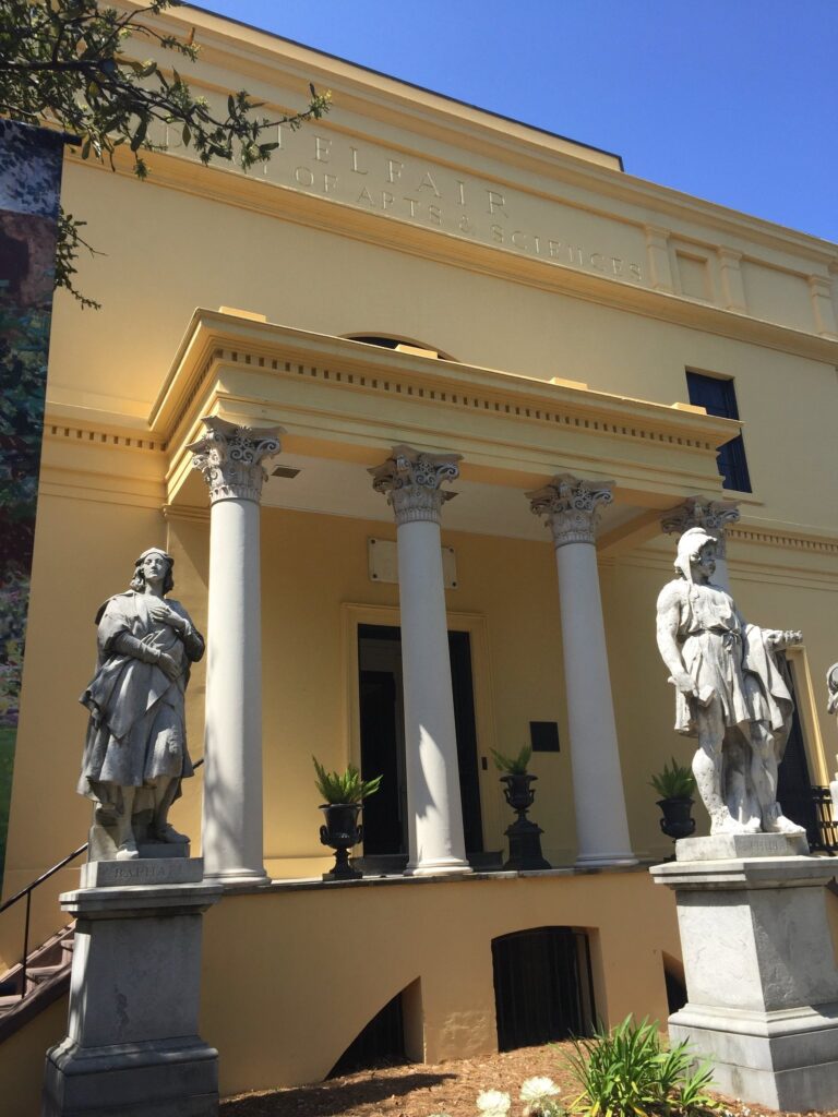 The columned entrance of the Telfair Academy in Savannah, flanked by large marble statues