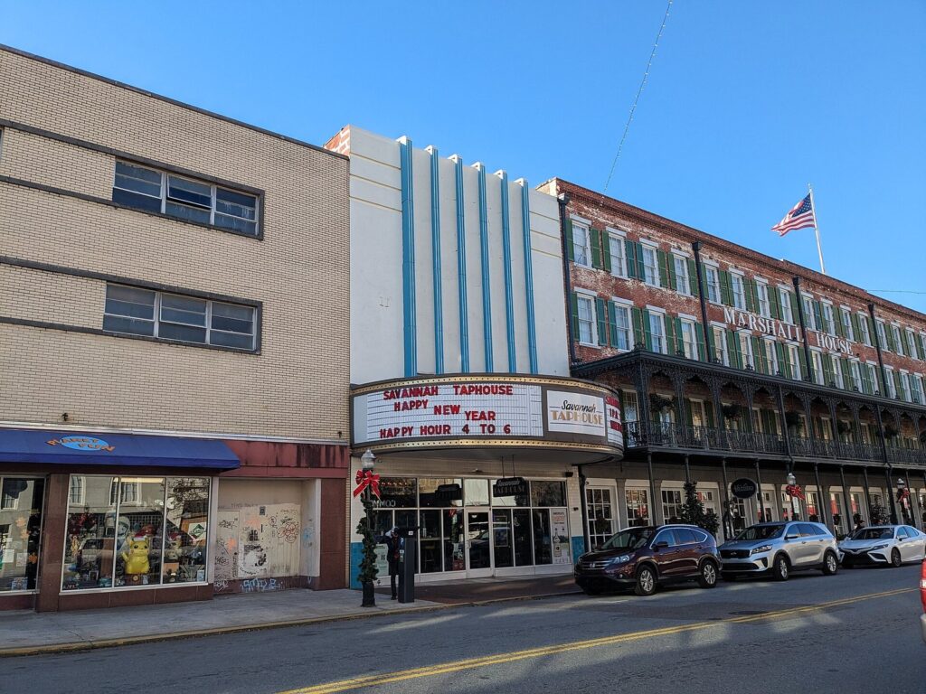 Shopfronts and the iron-balconied Marshall House hotel along Broughton Street in Savannah's Historic District