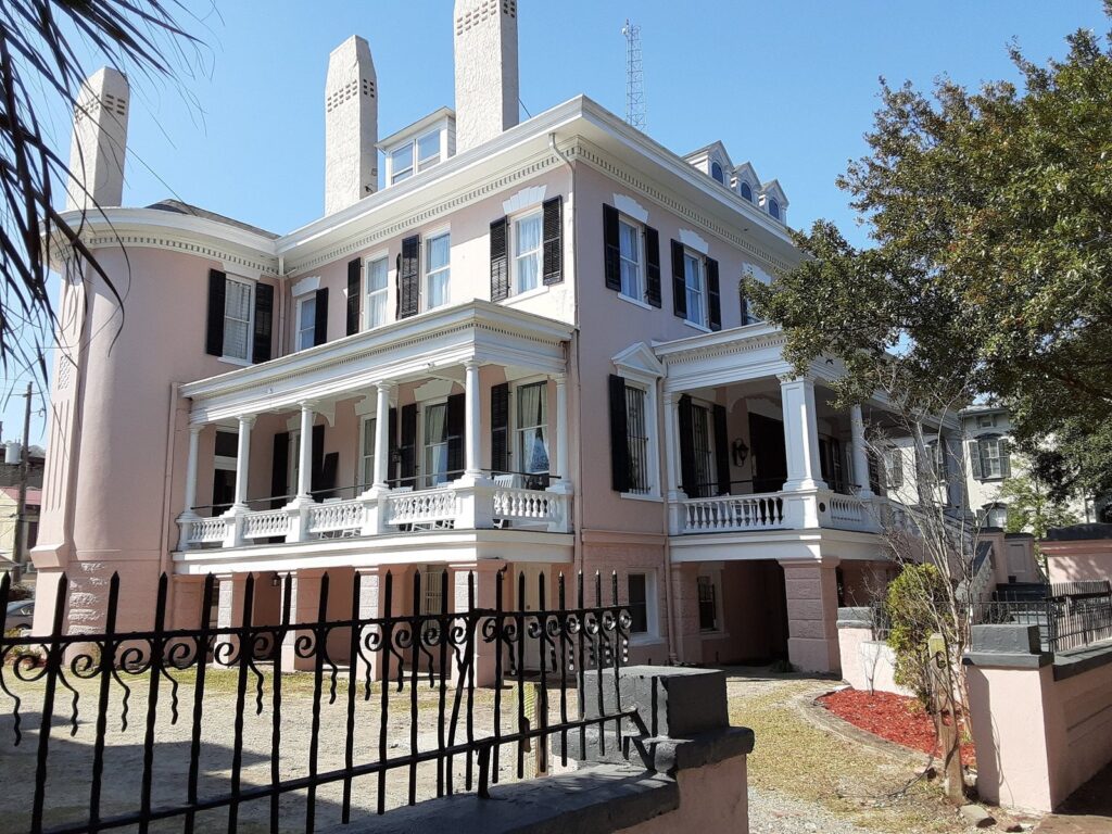 Pink Greek Revival mansion on East Gaston Street in the Historic District, the best area to stay in Savannah for first-time visitors