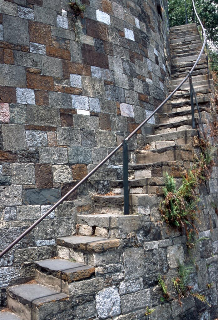 Steep, worn stone stairs climbing the bluff wall between River Street and Bay Street in Savannah