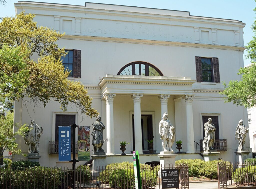 The columned facade of the Telfair Academy in Savannah, with marble statues of artists along its front